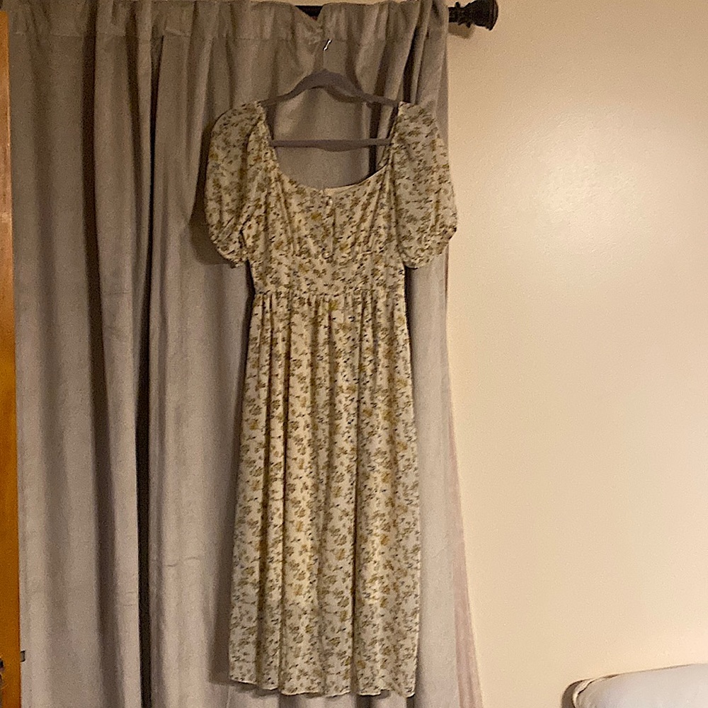 Dress with yellow flowers and smocking .  Never worn. From non smoking home